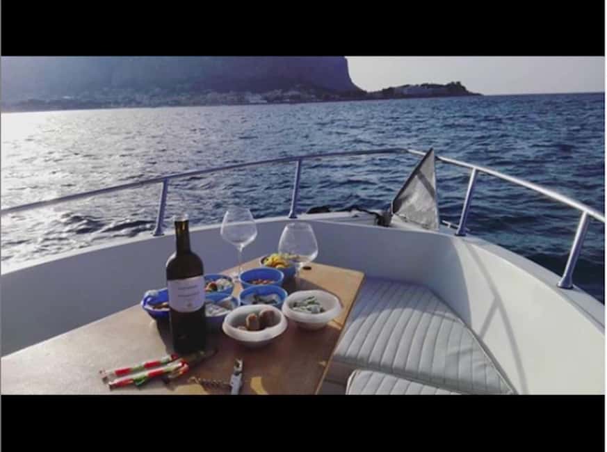 Aperitif on a boat at sunset at the Queen Cave - The last light over Villa Igiea