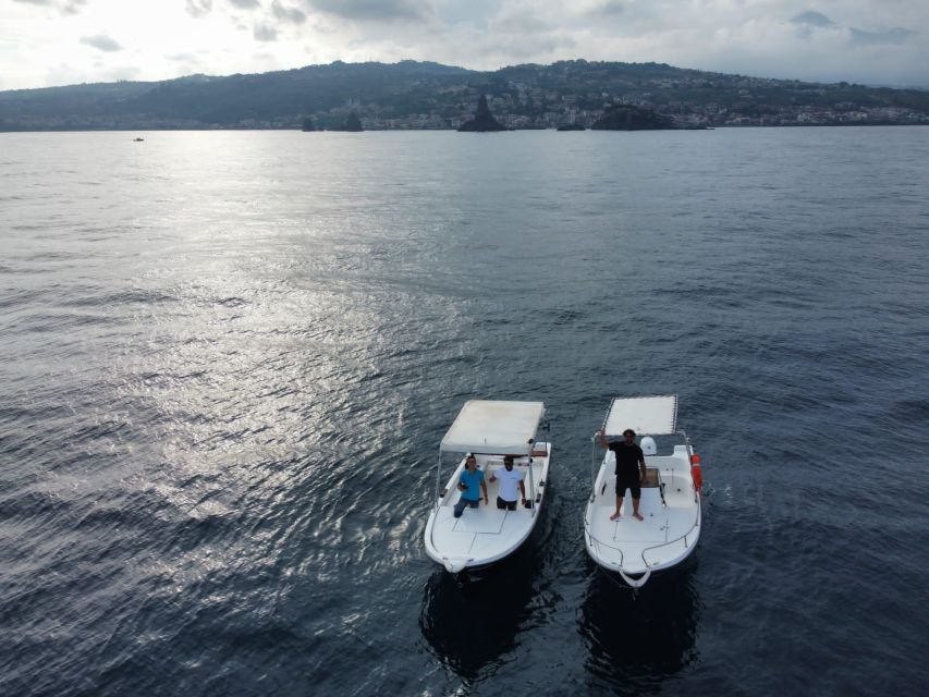 boat tour exploring and searching for dolphins in Acitrezza - The Faraglioni and the Cyclops legend