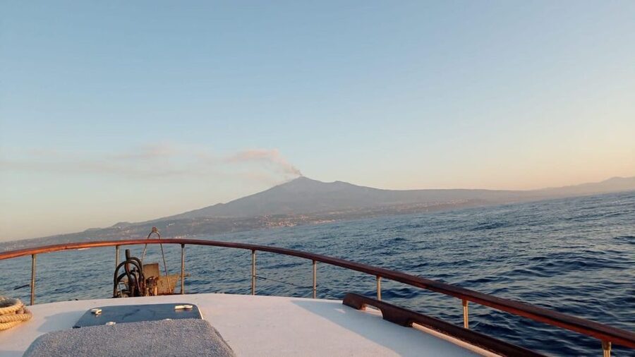 BOAT TOUR WITH APERITIF ON BOARD IN THE CYCLOPS ISLANDS - Sunset from Aci Trezza, with Etna in the distance