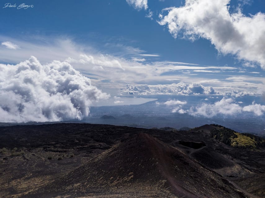From Catania: Mount Etna Trekking Private Experience - Entering a volcanic cave with a helmet and torch