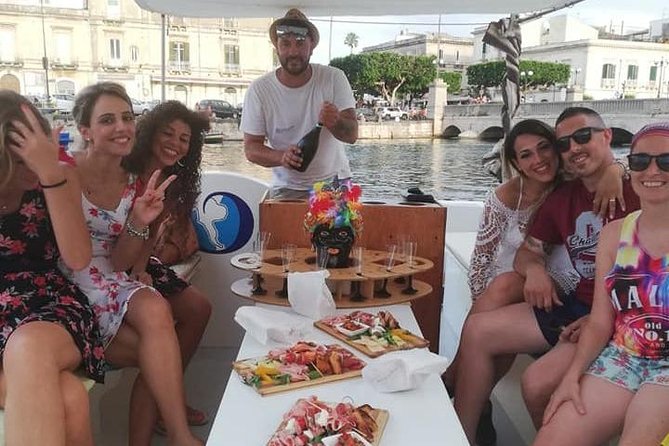 Syracuse Aperitif boat at Sunset island and sea caves - The Grotta dell’Amore photo stop