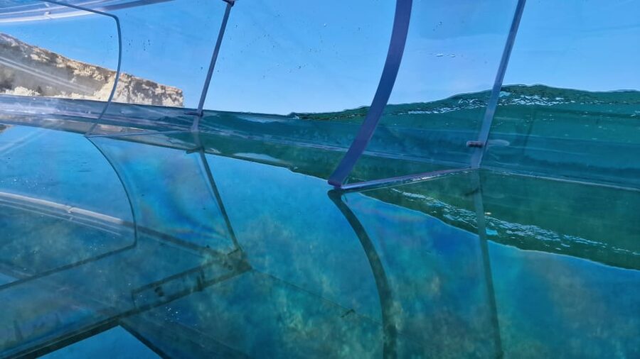 Syracuse: Coast and Sea Caves Full Transparent Boat Tour - A clear-bottom boat with a very different view