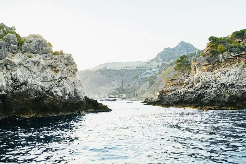 Taormina: Sunset Boat Tour with Dolphin Watching & Aperitif - Caves and rock formations along the Taormina coast